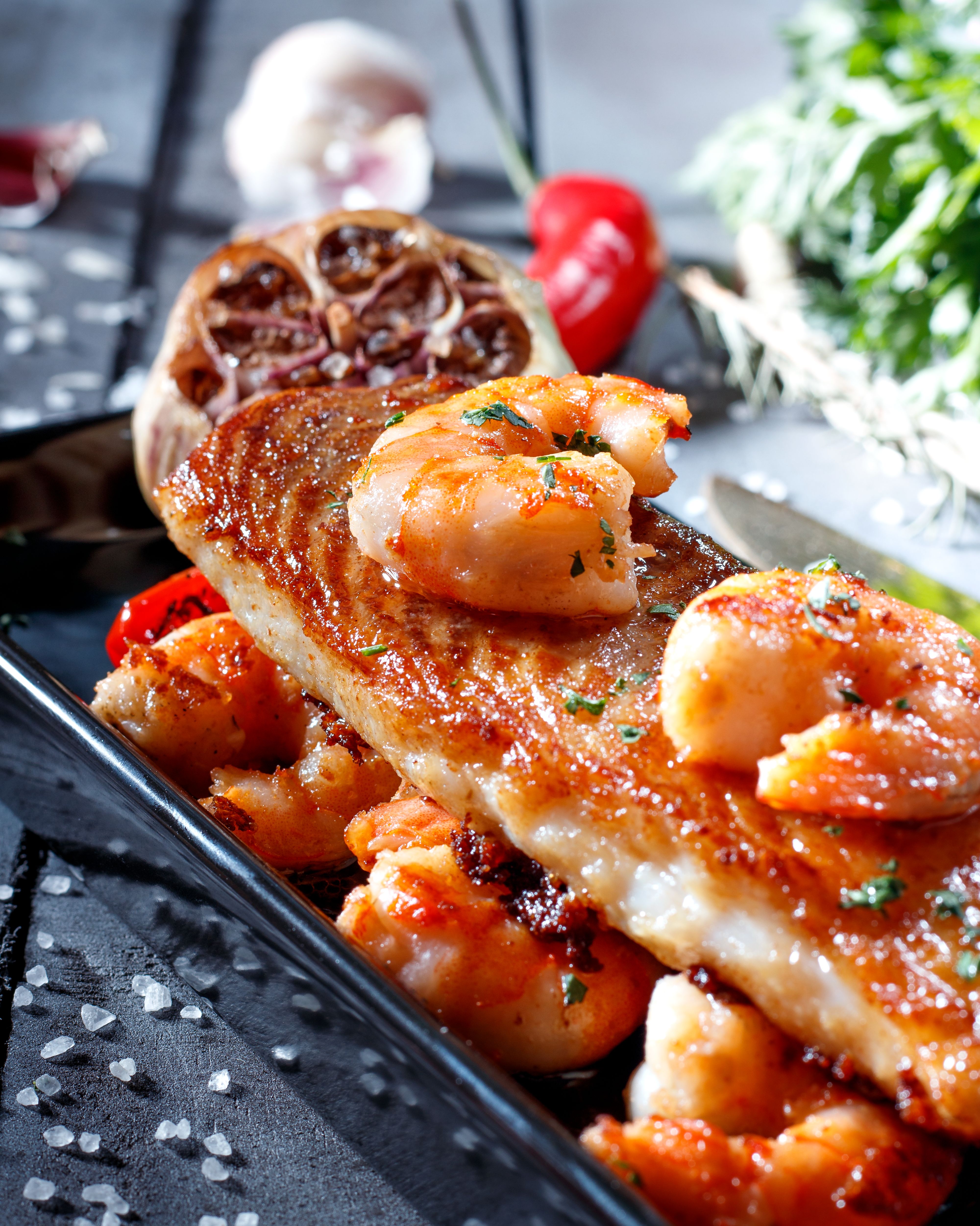 Seared fish topped with shrimp for coastal catering in Galveston
